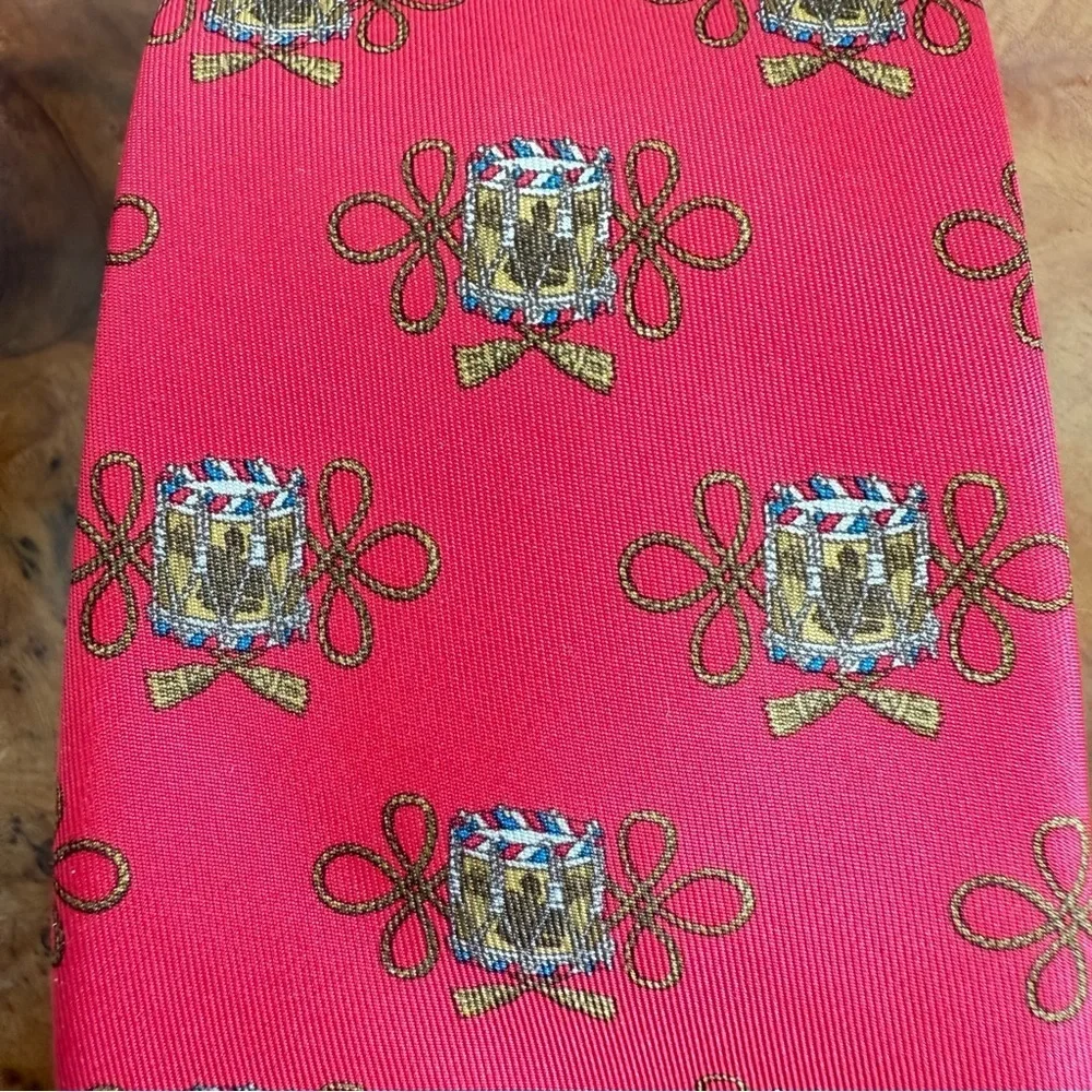 Vintage Hermès red silk tie with a repeating drum motif 3.5” x 54”
